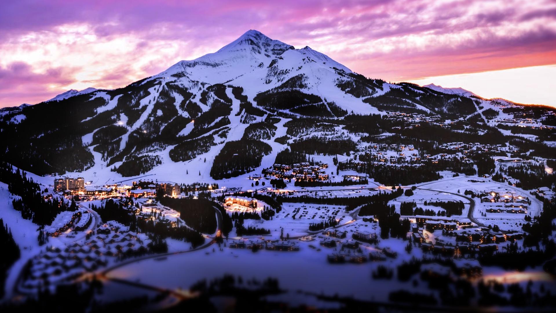 Lone Peak and Big Sky Mountain Village under alpenglow at dusk
